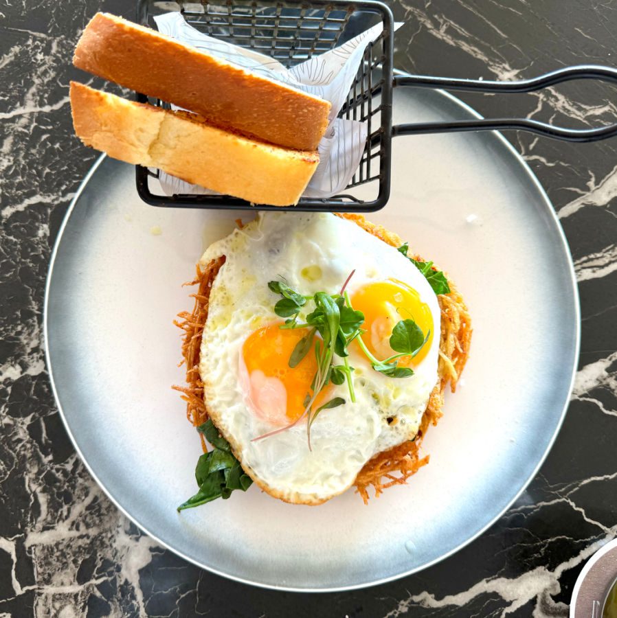 Fried egg atop a bed of hashbrowns with toast from Seaside Beach Club