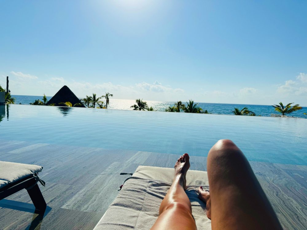 Lounging by the pool at the end of the day, blue sky and no one else at the pool at Impressions Moxché.