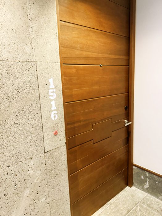 Picture of modern-style teak door as the entrance to a guest suite at the all-inclusive resort Impression Moxché in Playa Del Carmen, Mexico